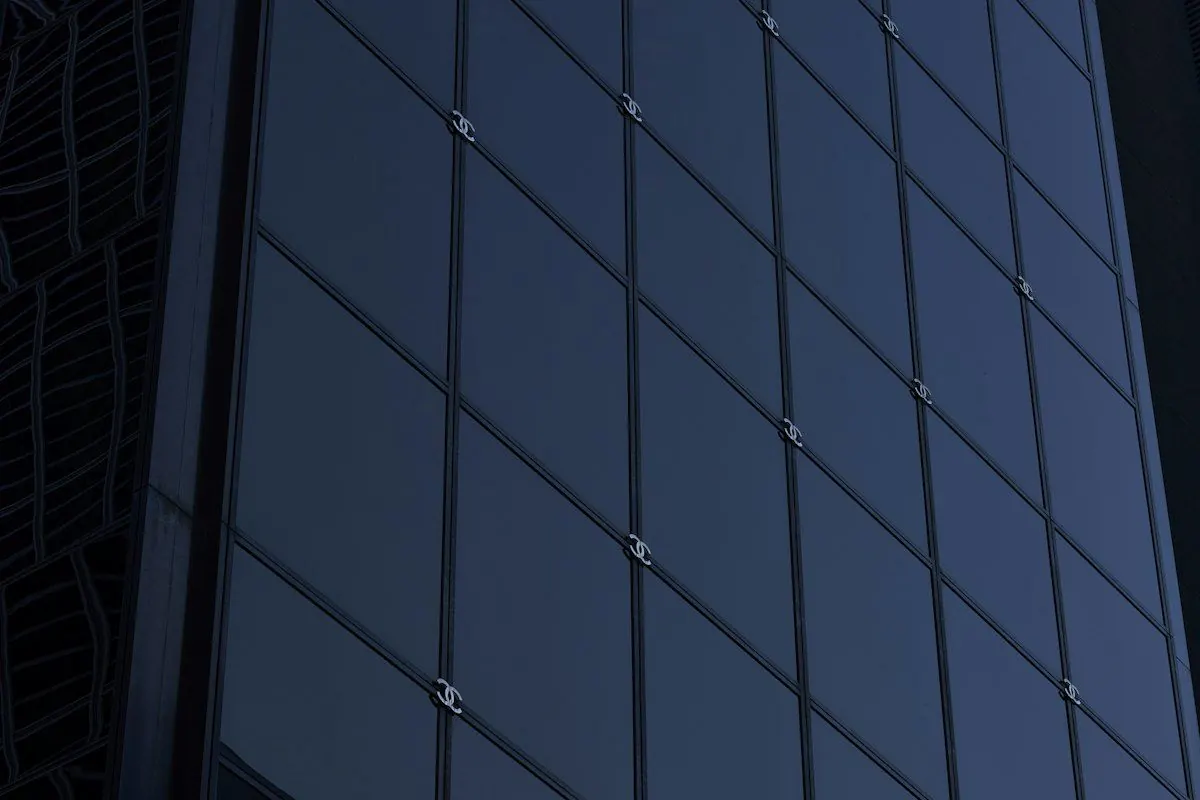 Dark glass building facade seen from below